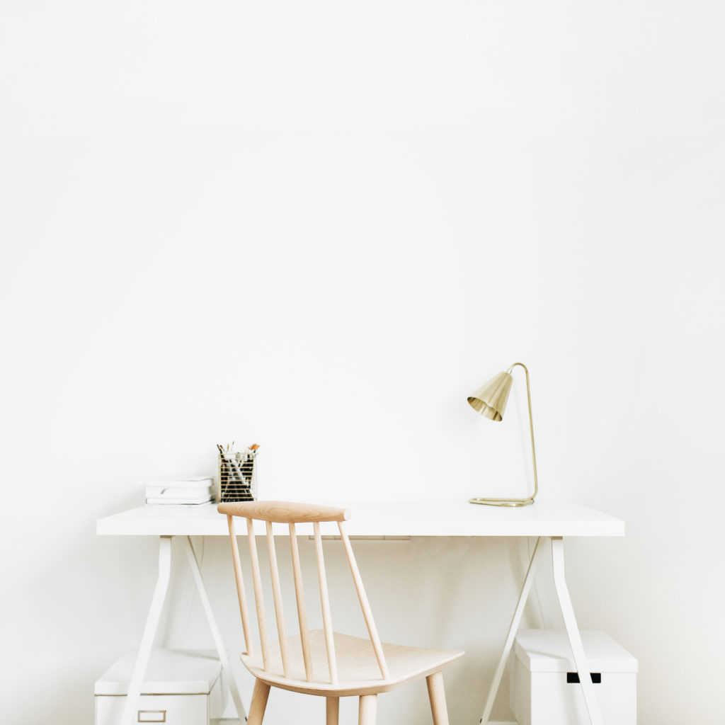 Bright home office desk workspace. Nordic modern minimal interior design concept. Desktop table and wooden chair in white room. Scandinavian style.